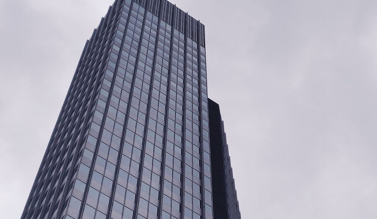 Modern high-rise building seen from below in a city business district