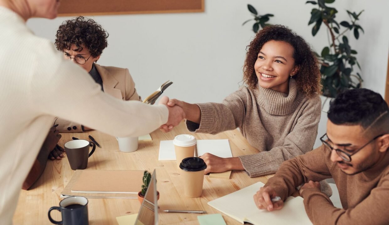 Colleagues shaking hands during a meeting about a property deal