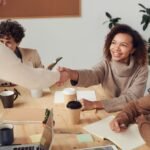 Colleagues shaking hands during a meeting about a property deal