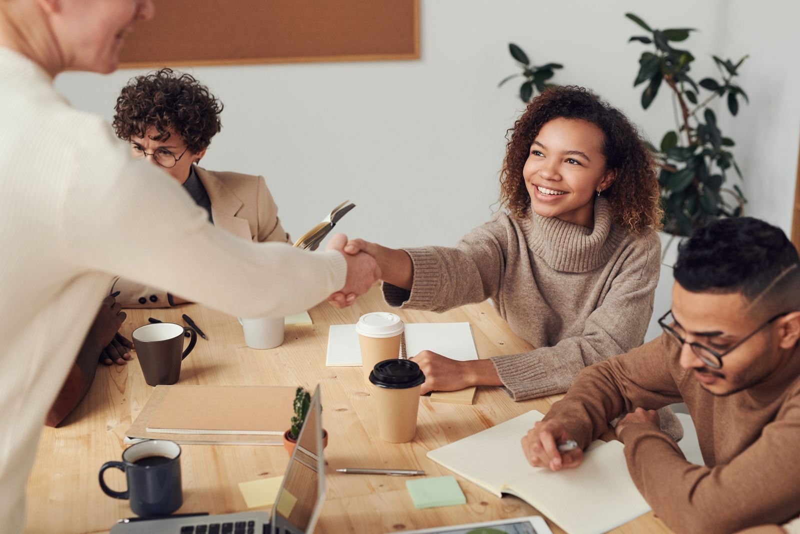 Colleagues shaking hands during a meeting about a property deal