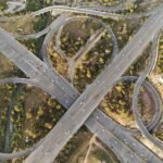 Aerial view of a highway interchange and green spaces in Islamabad