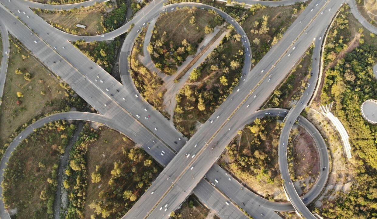 Aerial view of a highway interchange and green spaces in Islamabad