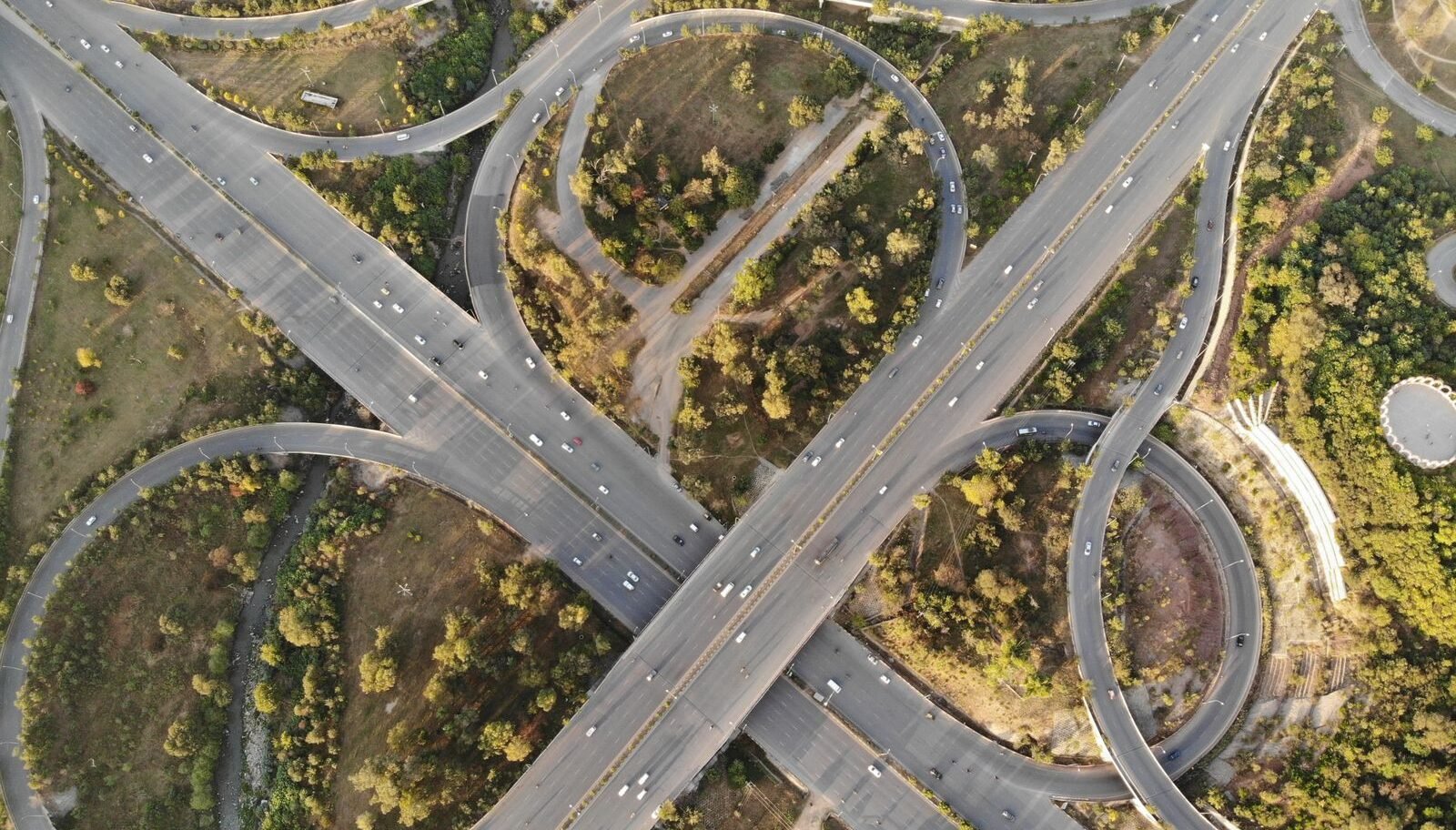 Aerial view of a highway interchange and green spaces in Islamabad